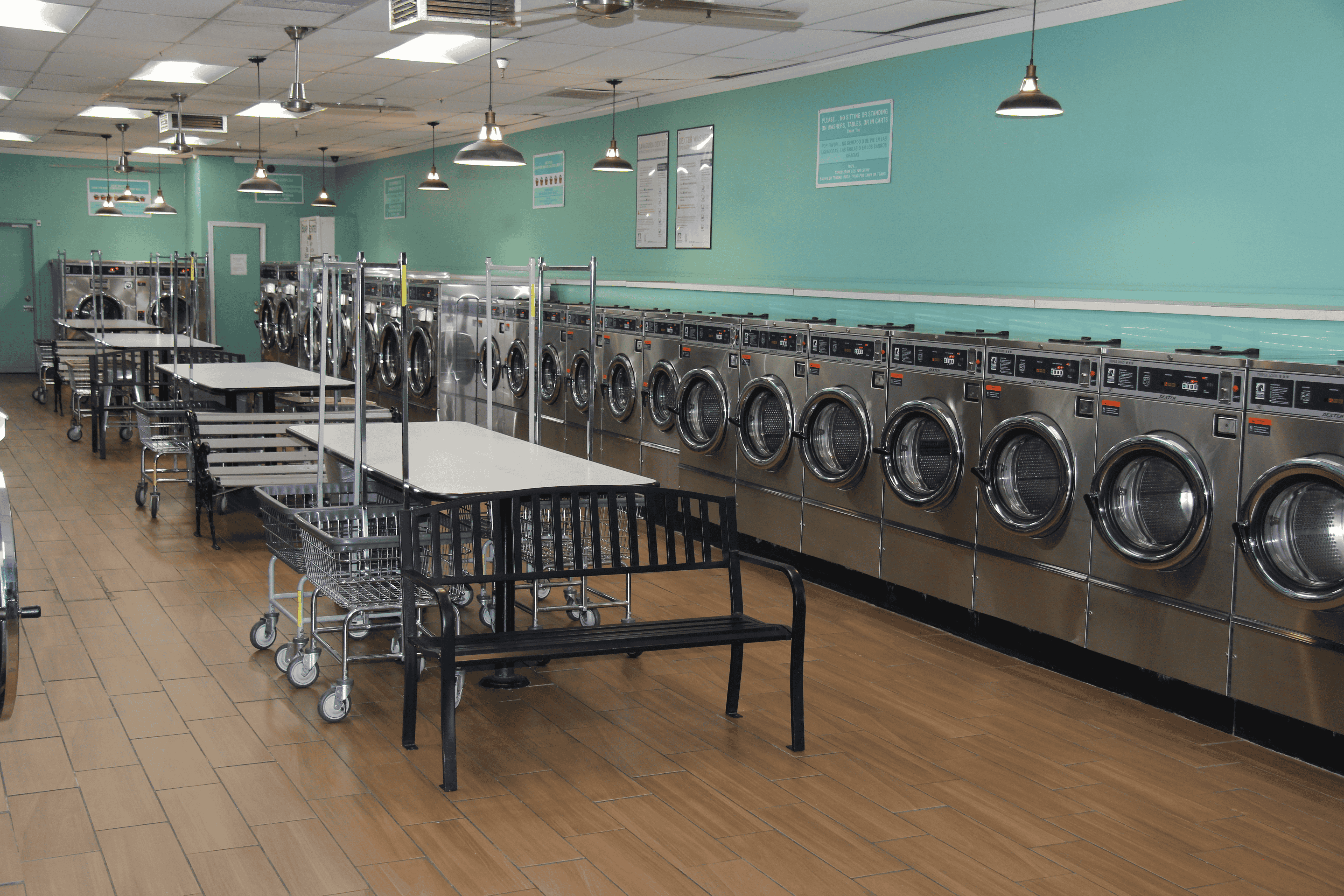 Modern laundromat interior with rows of washing machines